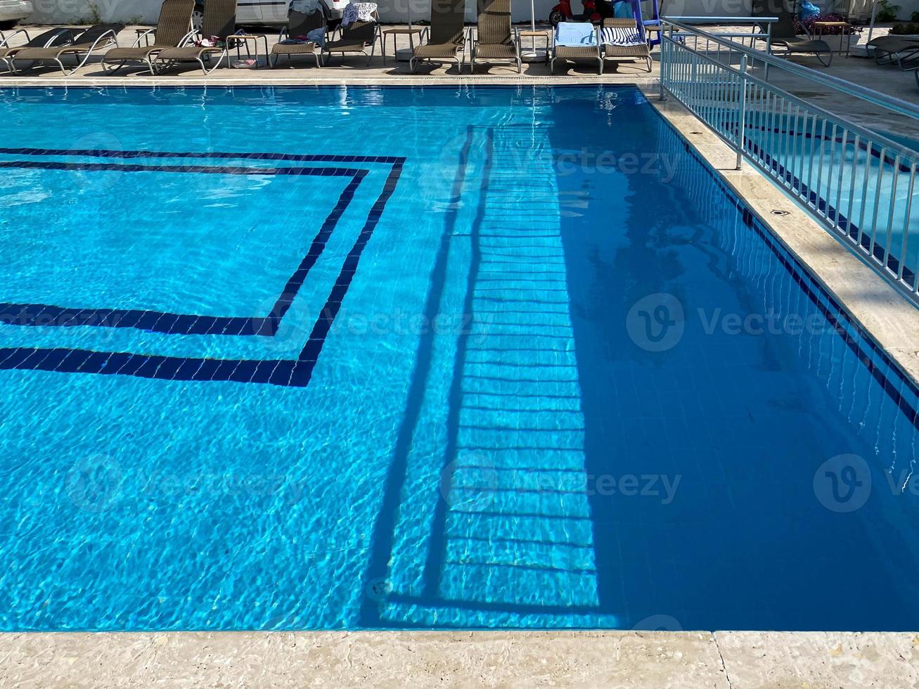 Small blue pool with ceramic tiles in a tropical resort hotel photo