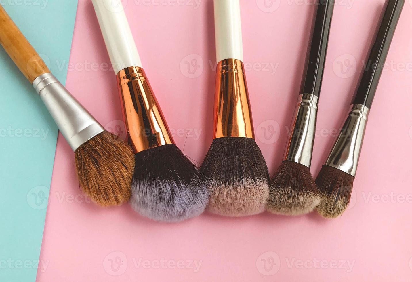 brushes lie on a bright background. fluffy brushes with natural bristles for applying textures to the face. beautiful face, brushes for eyeshadow, powder and blush photo