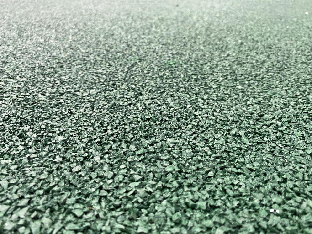Close up of soft rubber tiles for covering at outdoor gym of stadium at preschool yard photo