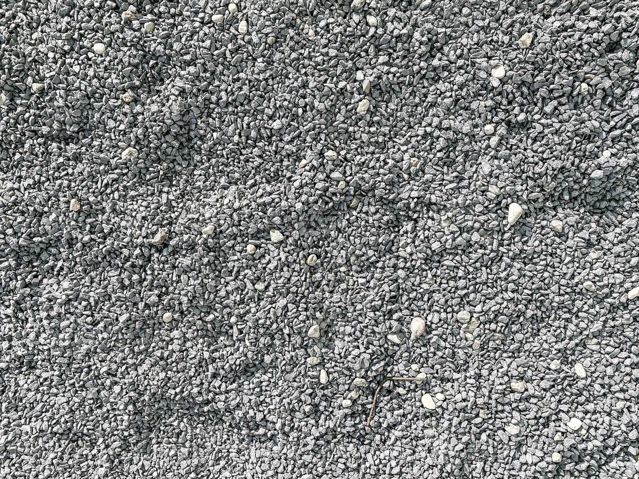 Small gray and white with black bright loose stones fashionable sharp beautiful used for decoration and landscape design. The background. Texture photo