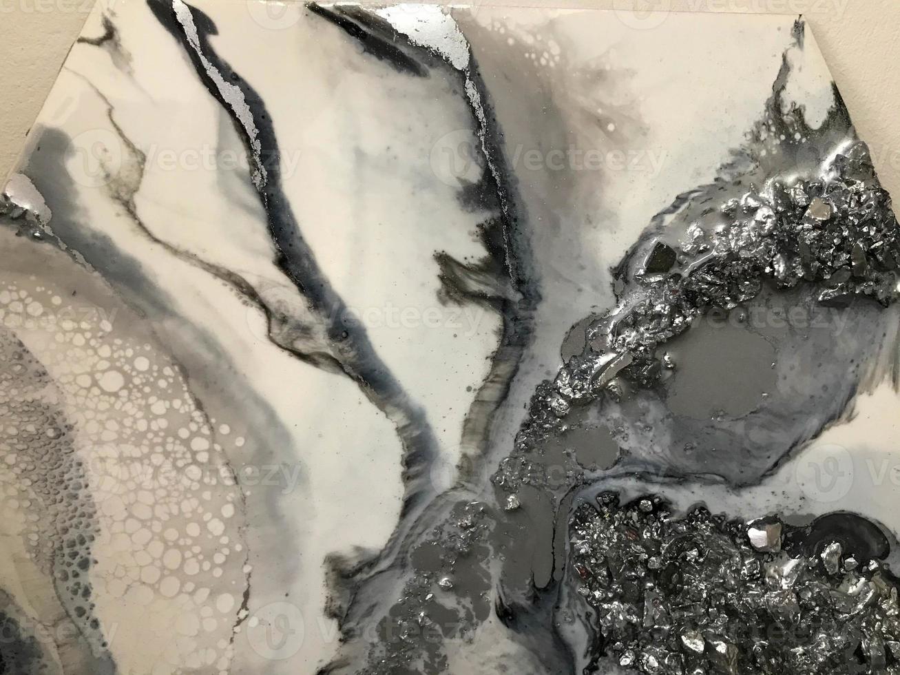 Bright surface abstract texture of canvas with stains of volumetric convex epoxy resin marble black and white creative multi-colored. The background photo