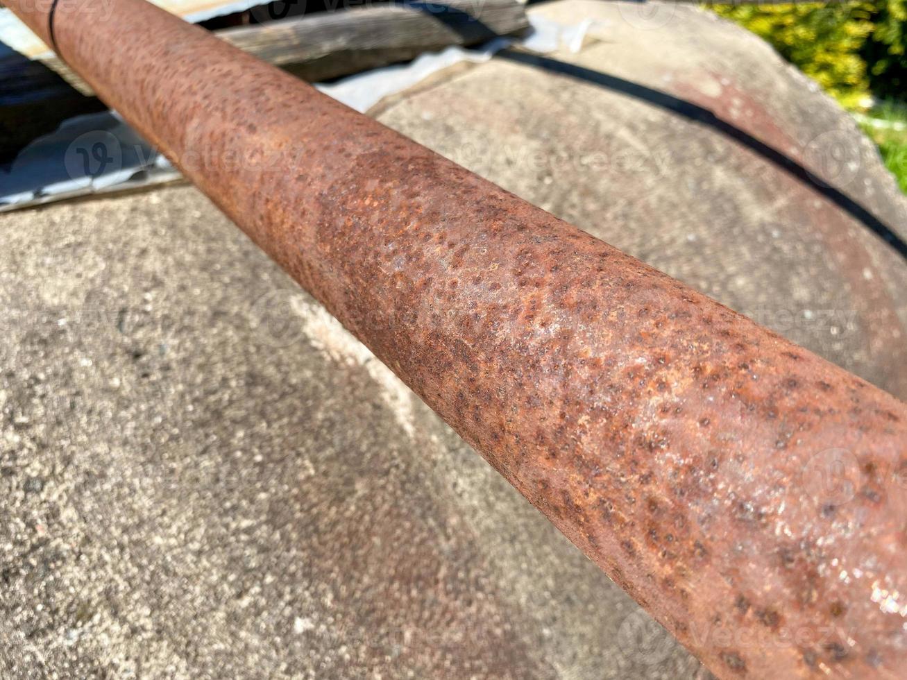 Rusty iron metal industrial pipe of large diameter old with holes for pumping liquid and construction in an oil refinery, petrochemical plant photo