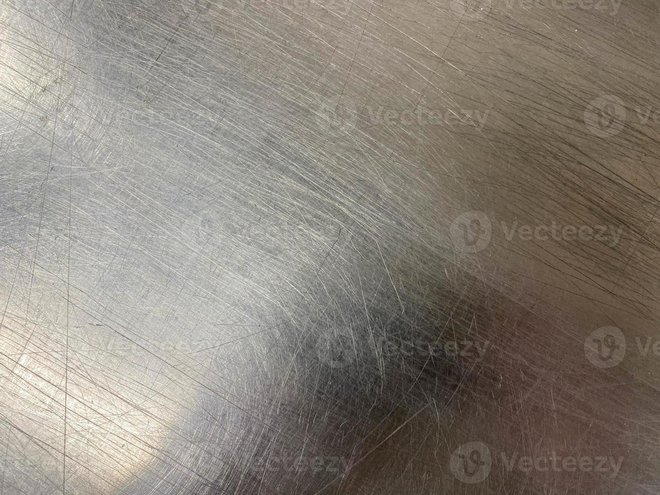 Texture of a shiny chrome-plated metal iron surface with minor scratches and abrasions. The background. Texture photo