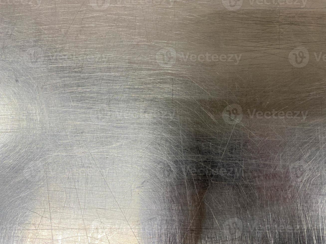 Texture of a shiny chrome-plated metal iron surface with minor scratches and abrasions. The background. Texture photo