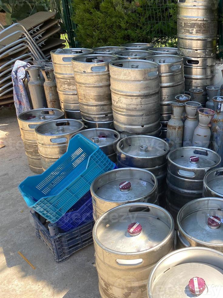 Steel industrial barrels of beer stocked in storage photo