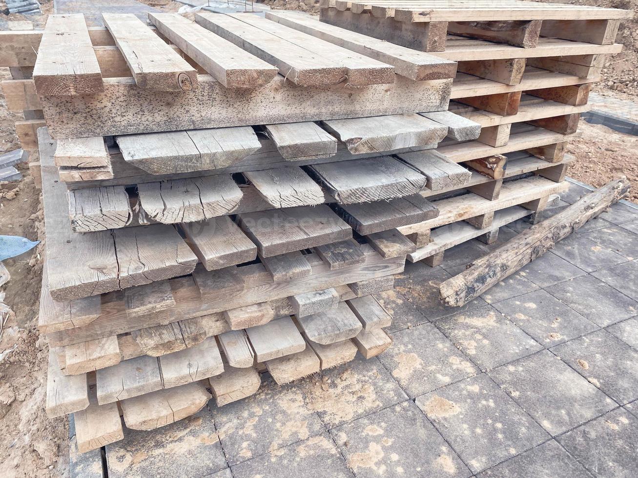 wooden pallets at the construction site. natural material for carrying heavy objects at a construction site. pallets for storage of building materials photo