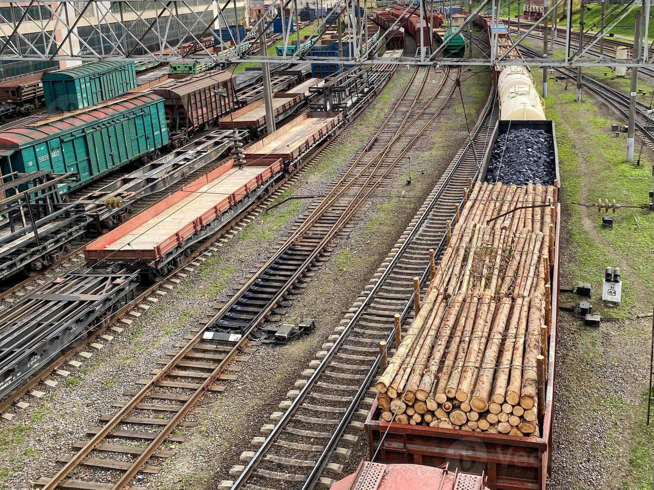 Top view of different railway wagons and tanks on an industrial railroad with rails for the transport of goods and improved modern logistics photo