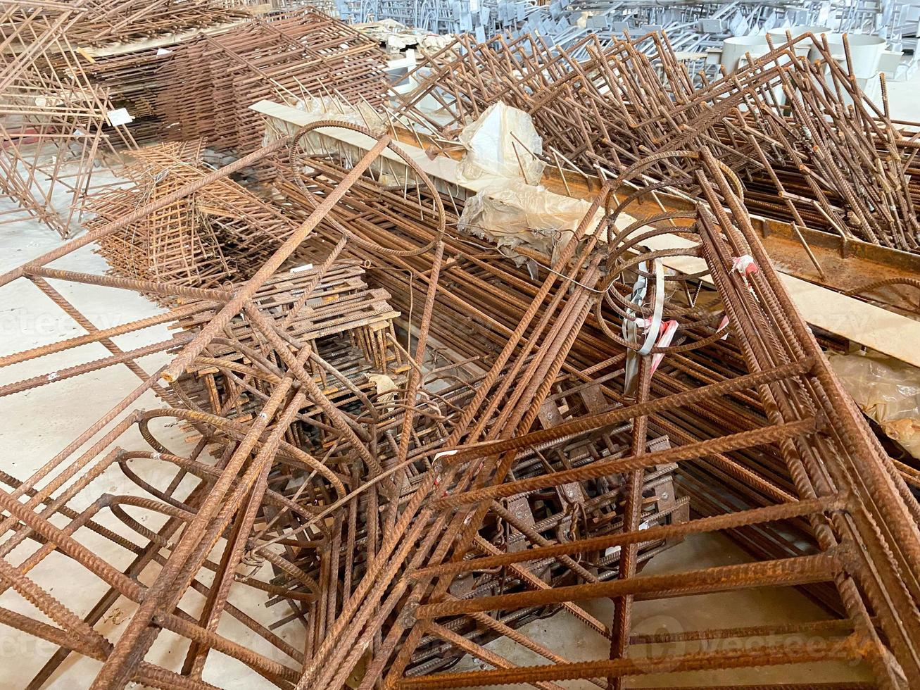 Iron rusty bars of wire reinforcement for building houses and producing industrial reinforced concrete at a construction site photo