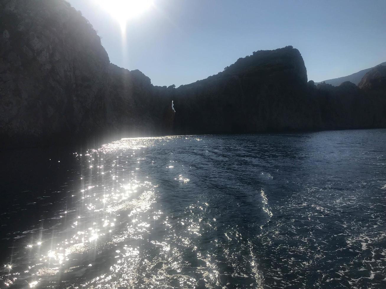Mountains by the sea in sun photo