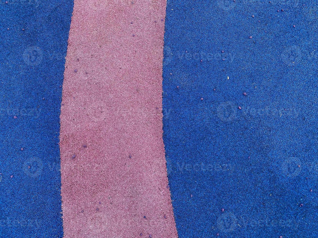 Blue and purple texture of the soft rubber surface of the safe cover of the sports playground for workout made of pressed fine rubber. The background. Texture photo