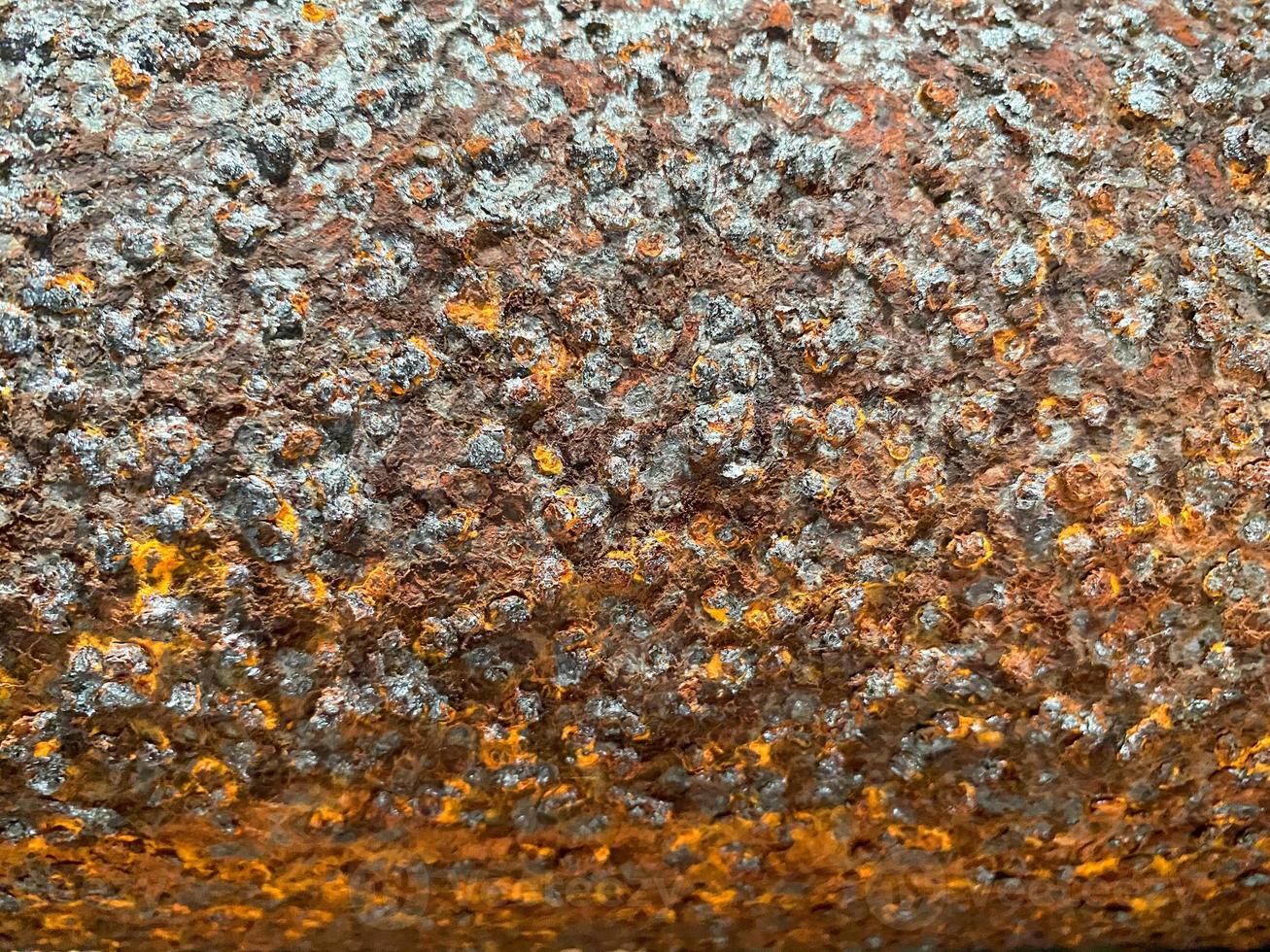 Surface texture of old metal iron swollen reddish orange surface of rusty bad pipe. Close view. The background photo