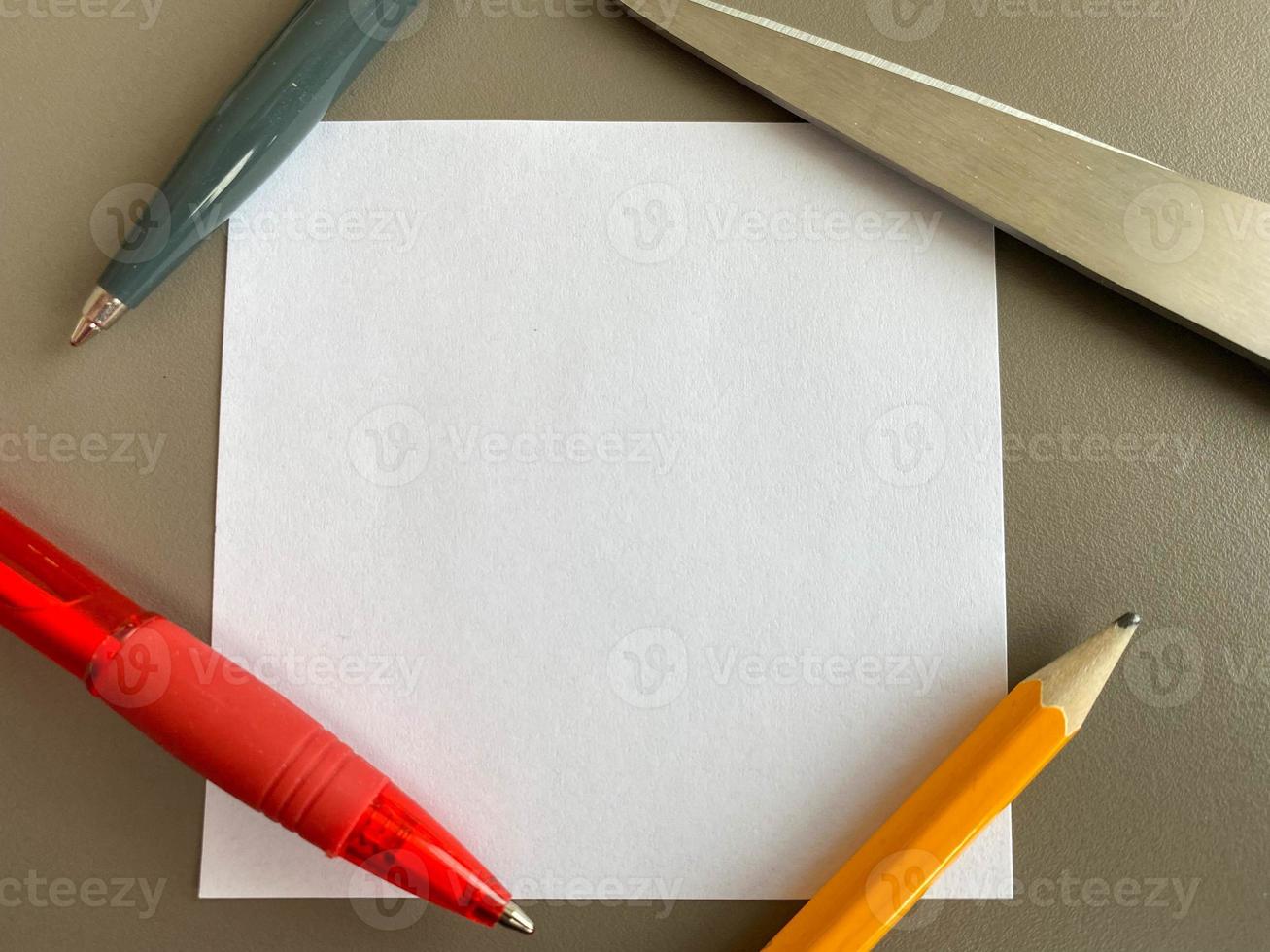 Small square pieces of paper for notes and notes on the office desk and ballpoint pens with pencils. Business work photo
