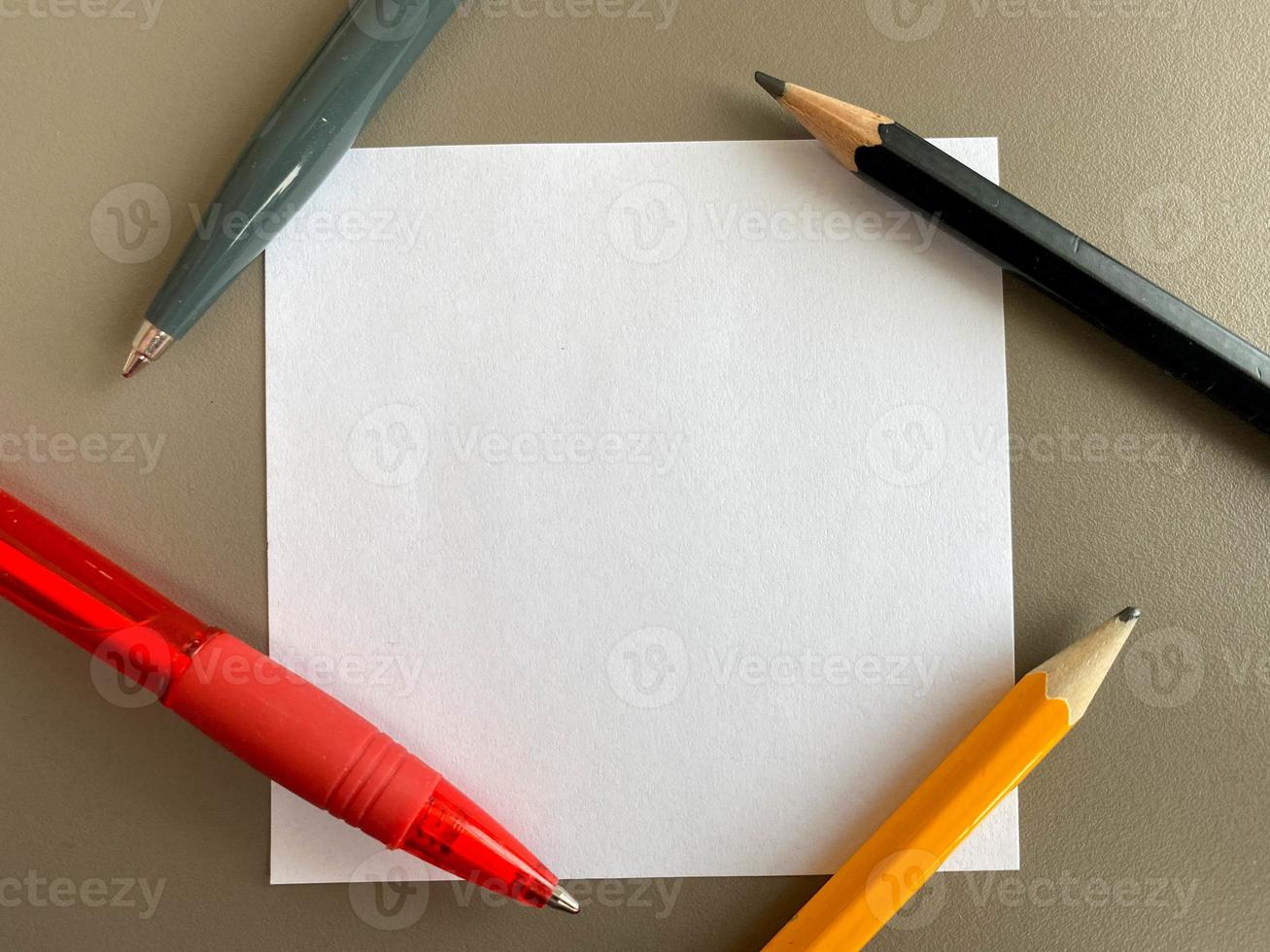 Small square pieces of paper for notes and notes on the office desk and ballpoint pens with pencils. Business work photo