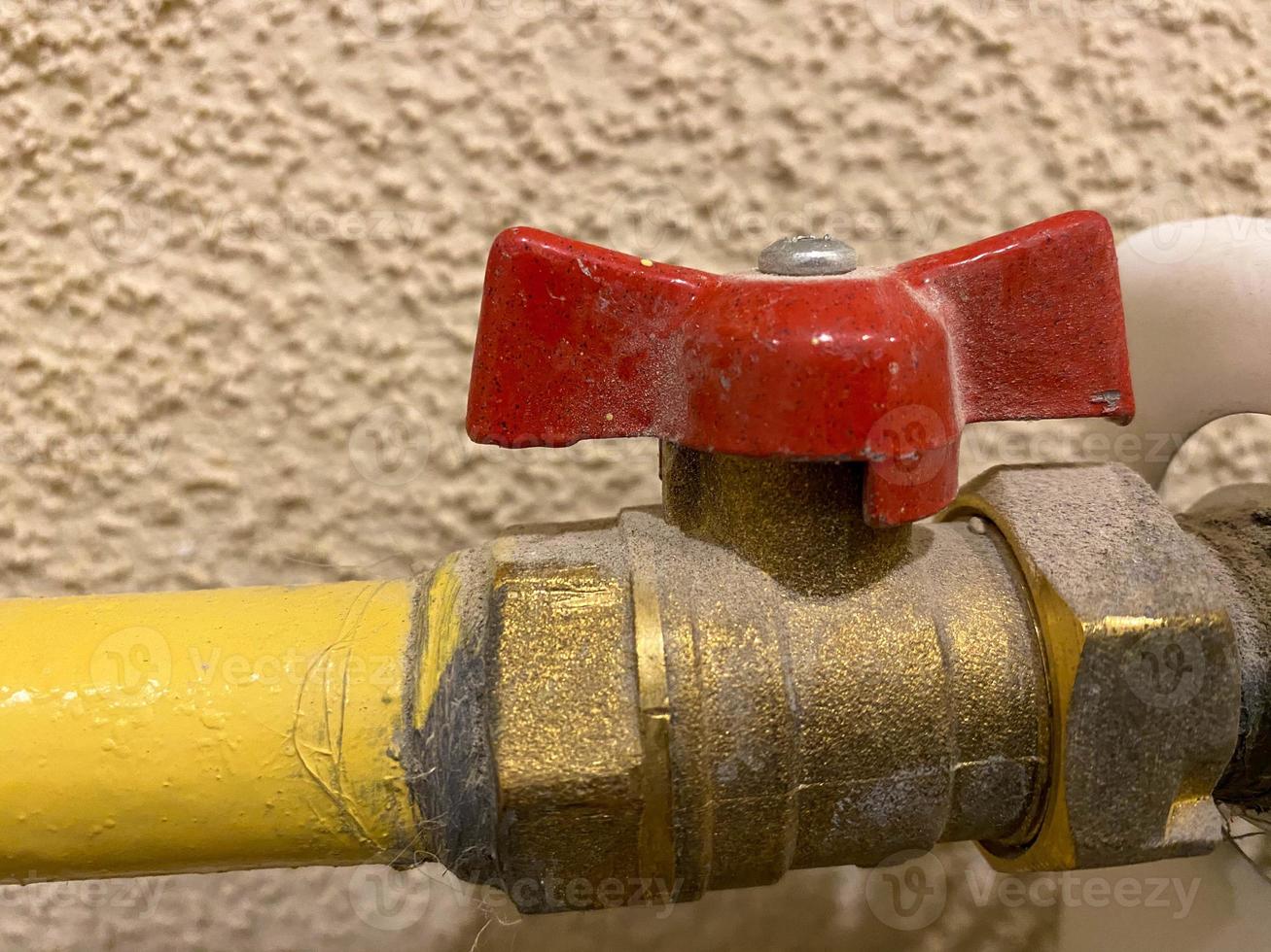 Bronze ball valve 3 4 inches with red handle for water close-up on isolated background. Plumbing details photo
