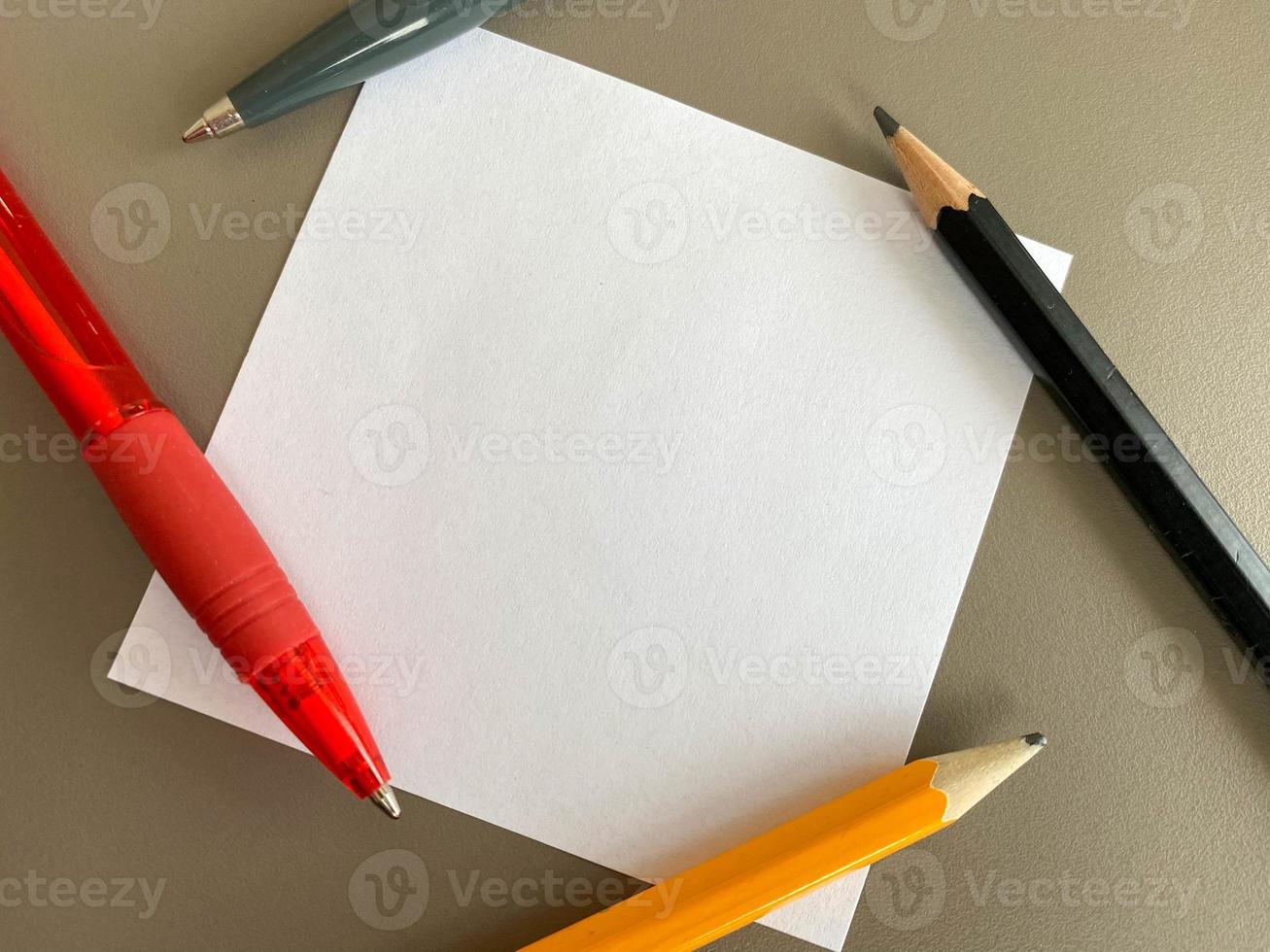 Small square pieces of paper for notes and notes on the office desk and ballpoint pens with pencils. Business work photo