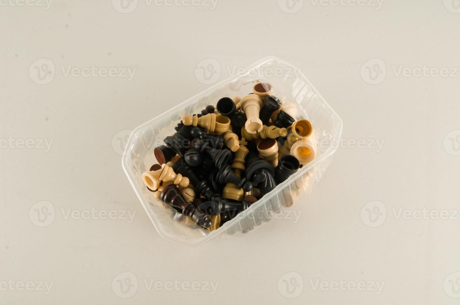 Chess pieces in container photo
