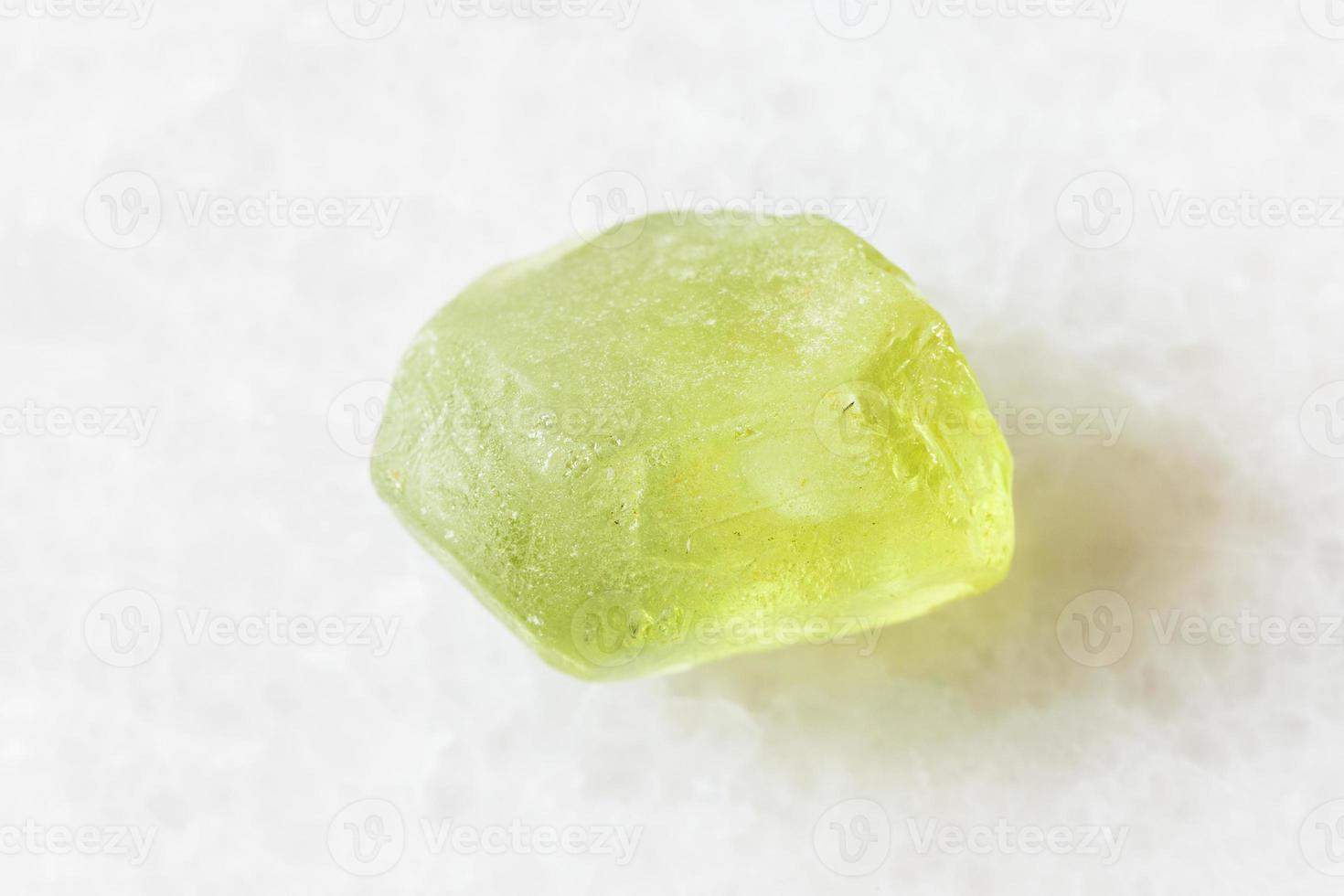 raw Olivine, Peridot, Chrysolite crystal on white photo