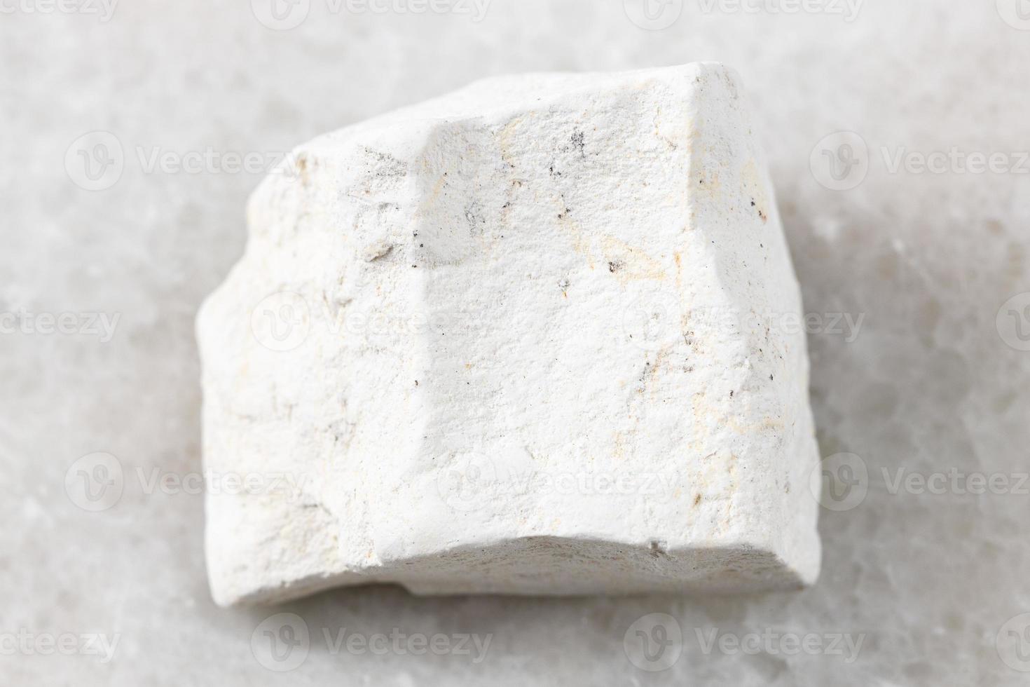 rough Chalk stone on white marble photo