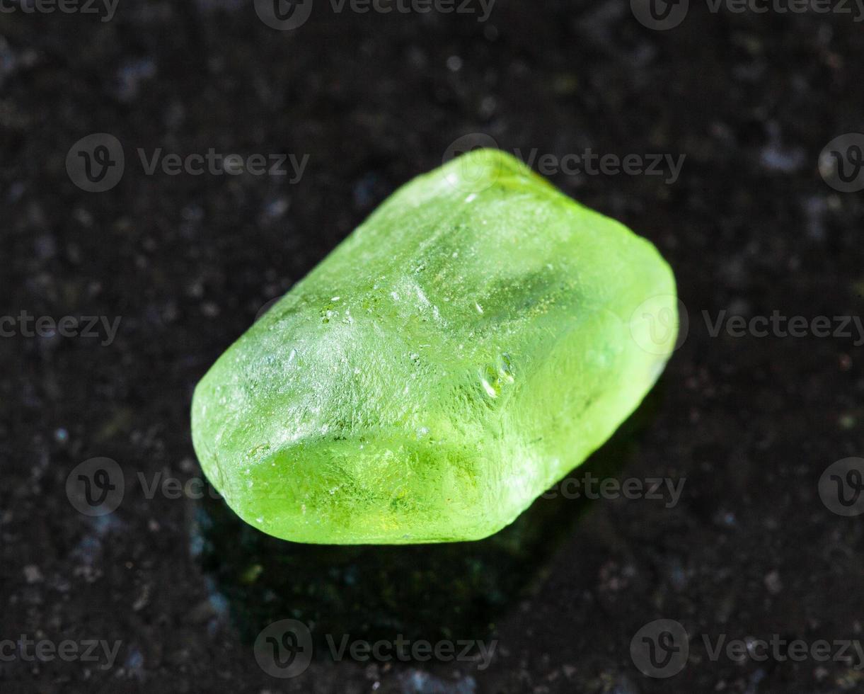 raw Olivine Peridot, Chrysolite crystal on black photo