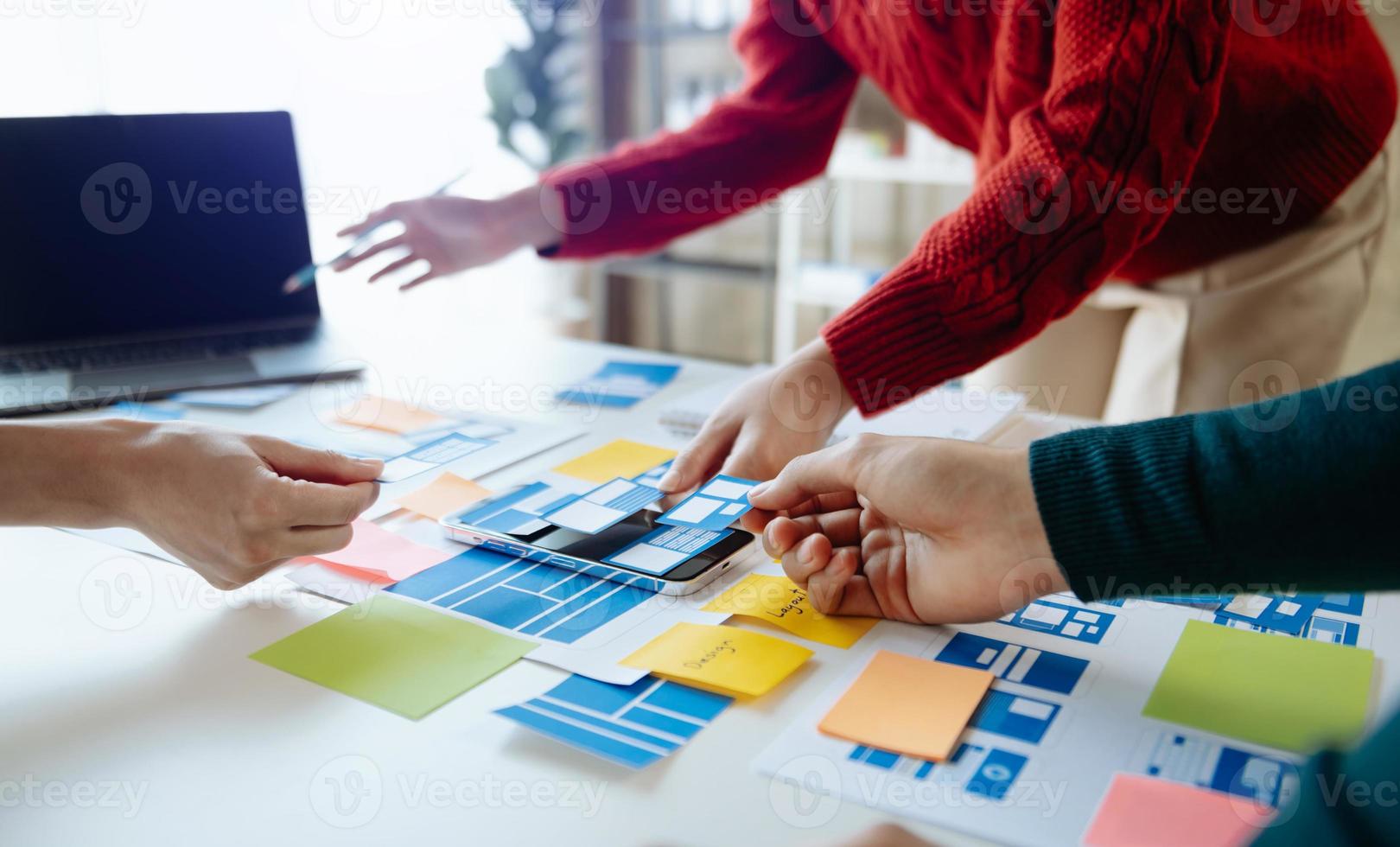 UX developer and ui designer brainstorming about mobile app interface wireframe design with customer breif and color code at modern office. photo