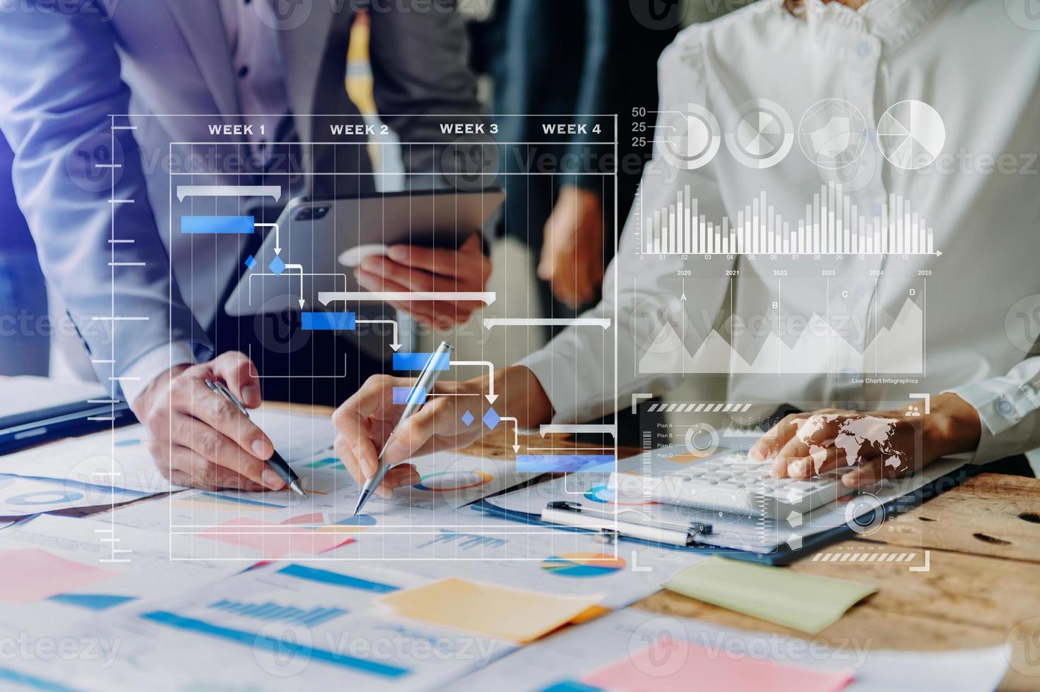 Businessman hand Project manager working and update tasks and Gantt chart scheduling virtual diagram.with smart phone, tablet and laptop in office. photo