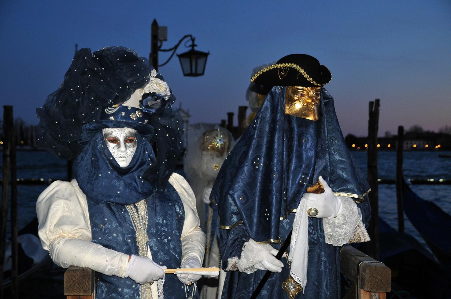 Unidentified people wearing carnival masks at the Venice Carnival in Venice, Italy, circa February 2022 photo