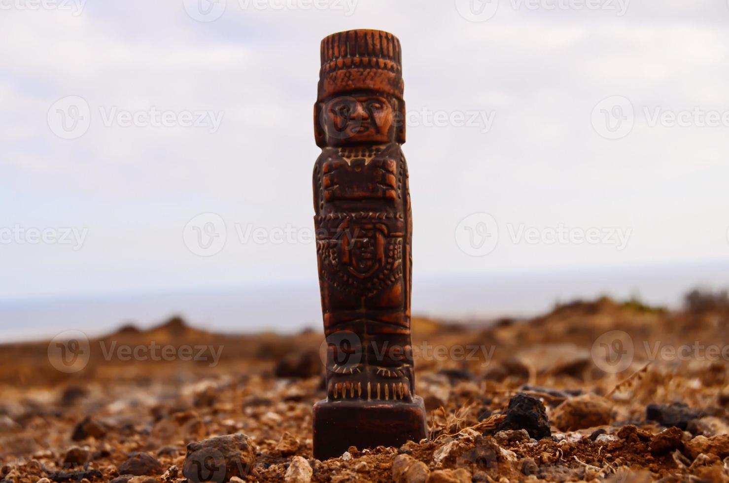 Pre-Columbian figurine on desert photo