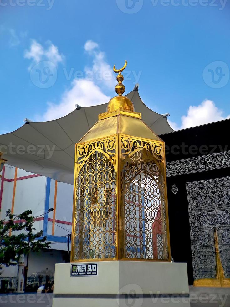 Replica of the Kaaba Golden Lantern, in Taman Madiun Indonesia, sunny weather. photo