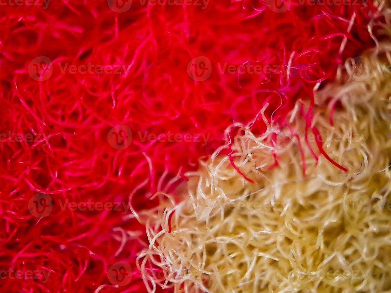 macro texture of red and gold home carpet fabric, suitable for wallpaper background. photo