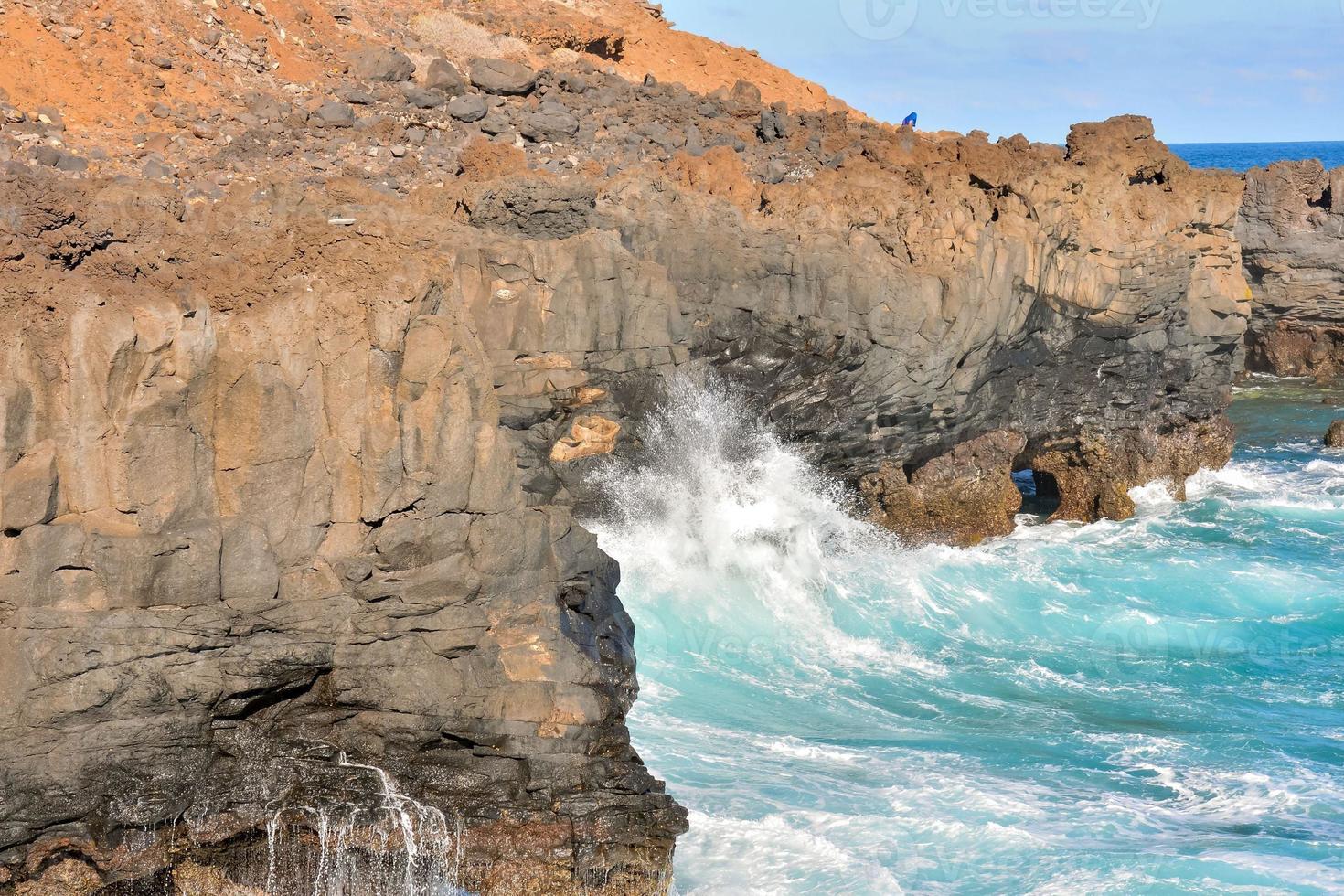 Waves hitting a rock scene photo