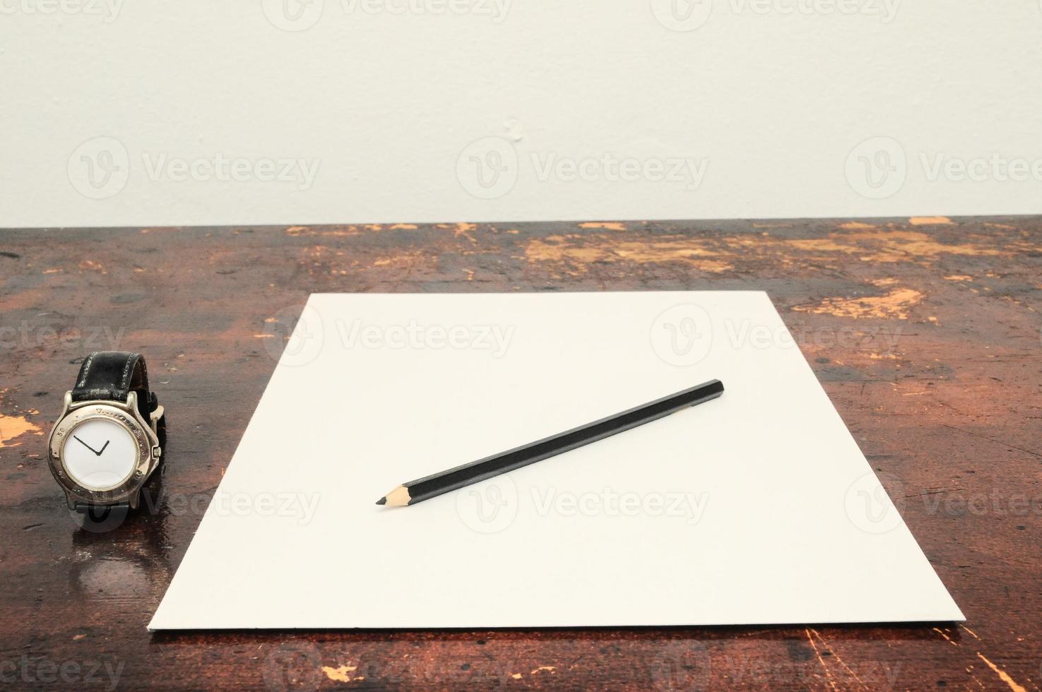 Paper and pencil on the table photo