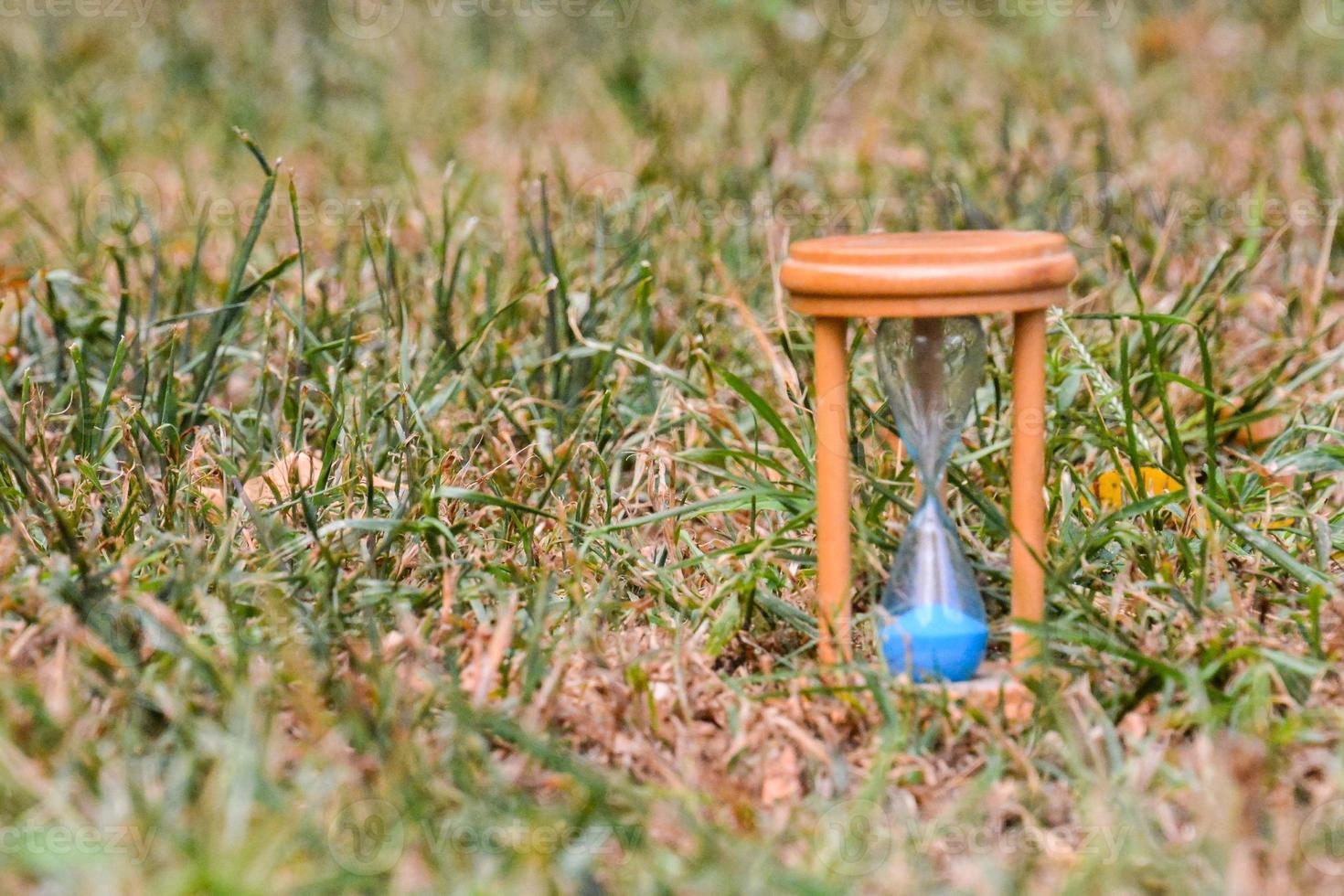 Hourglass in grass photo