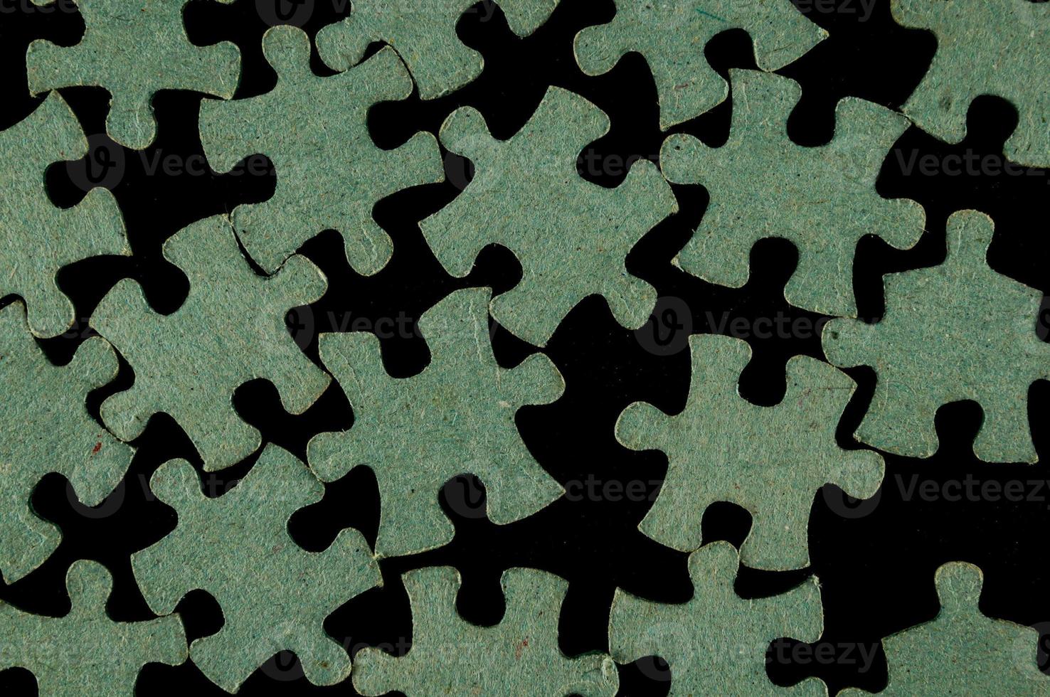 Puzzle pieces on black photo