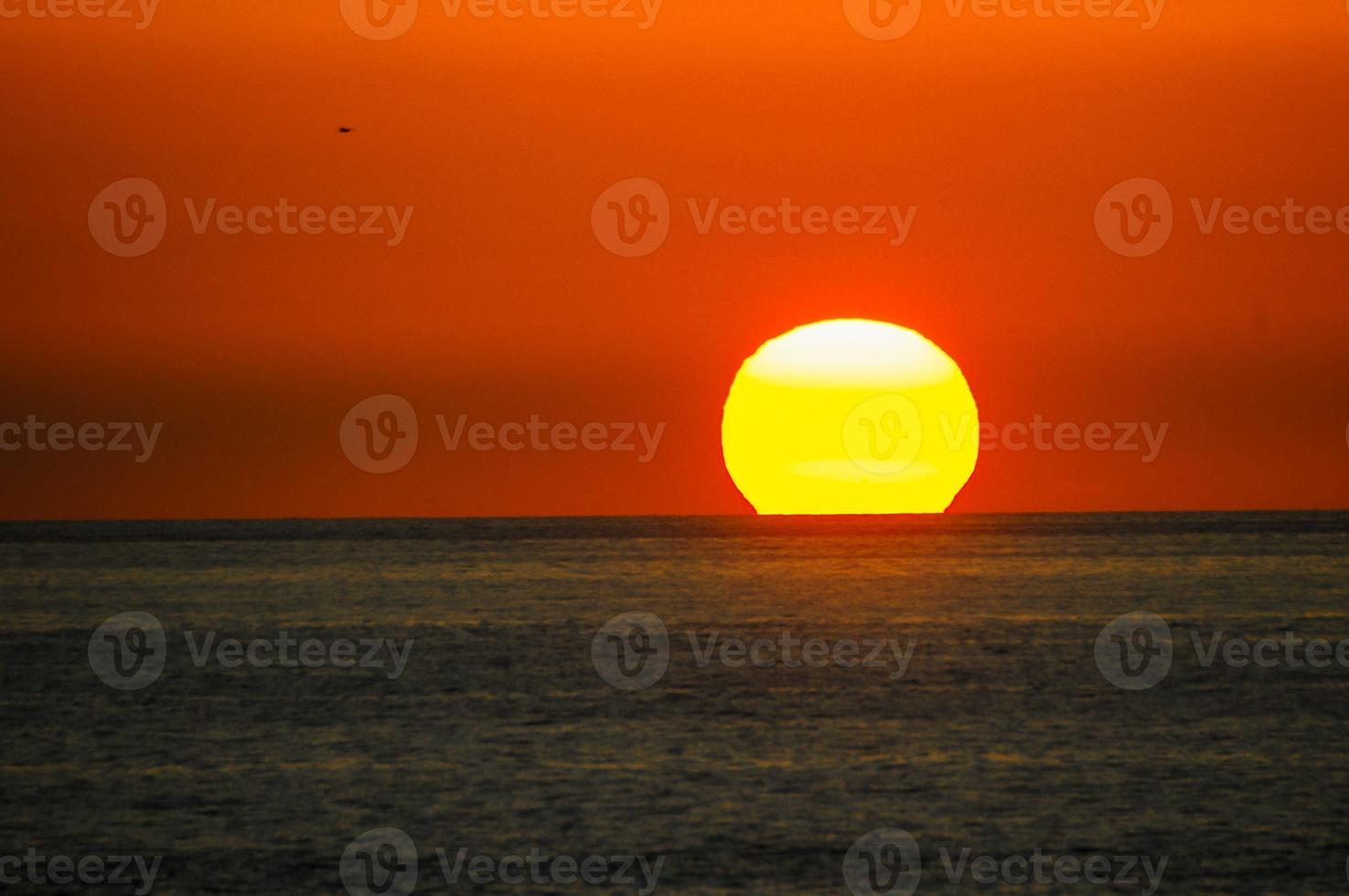 Sunset over the ocean photo