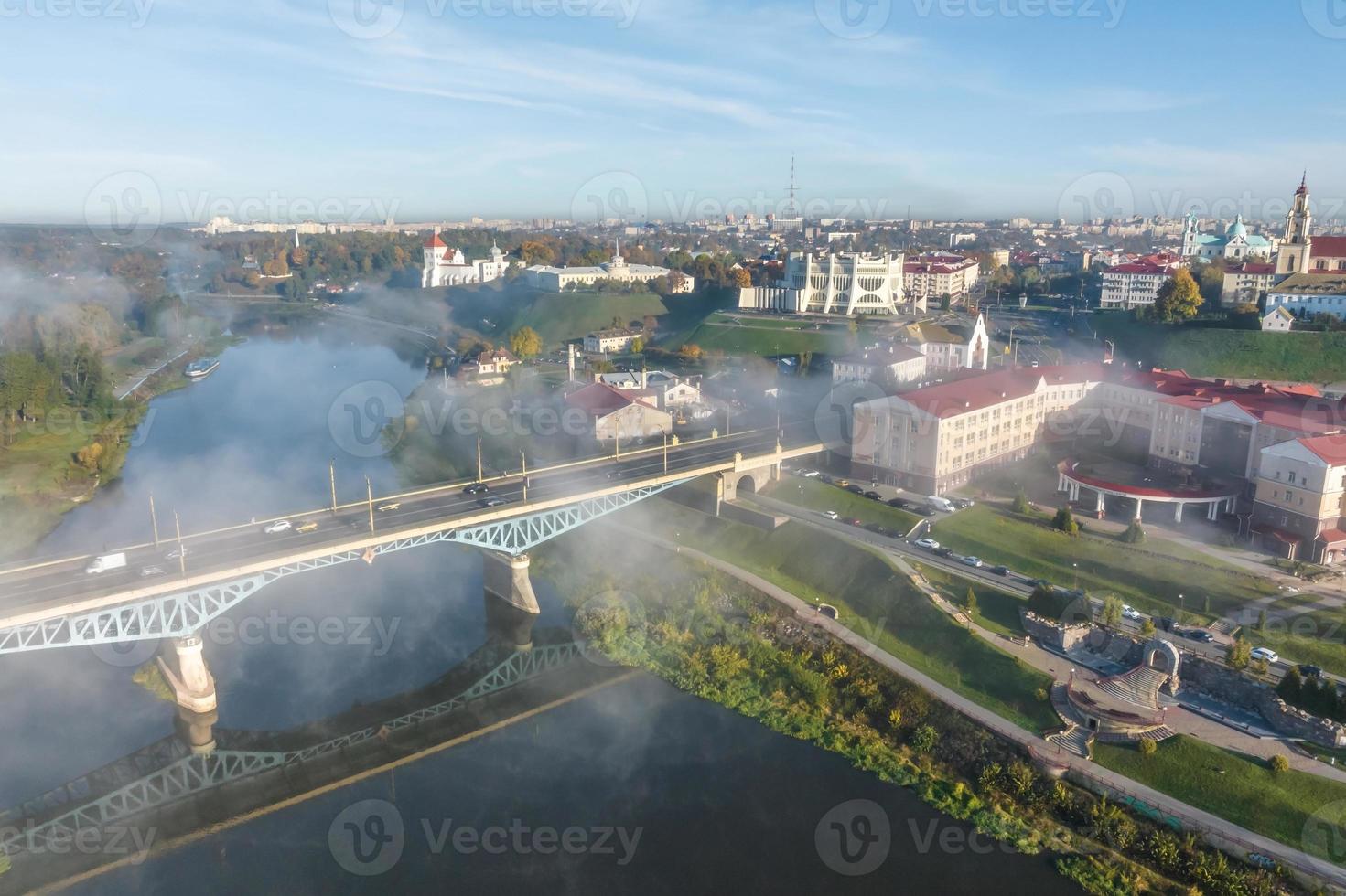 earlier foggy morning and aerial panoramic view on medieval castle and promenade overlooking the old city and historic buildings near wide river photo