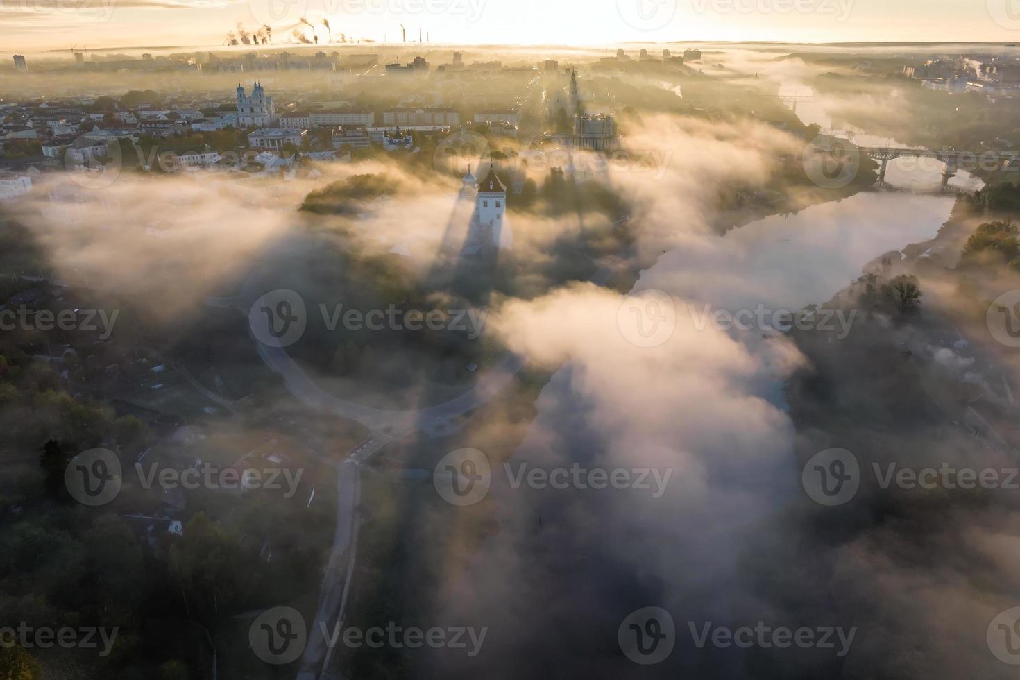 earlier foggy morning and aerial panoramic view on medieval castle and promenade overlooking the old city and historic buildings near wide river photo