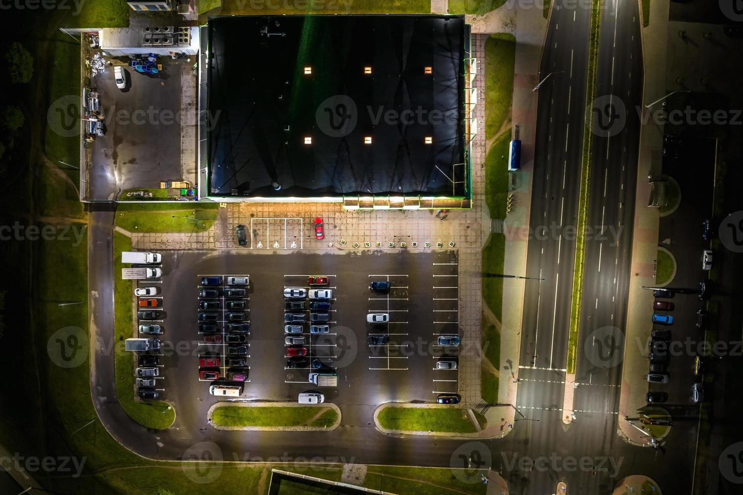 aerial night view on large open air parking lot for cars for residents of area photo