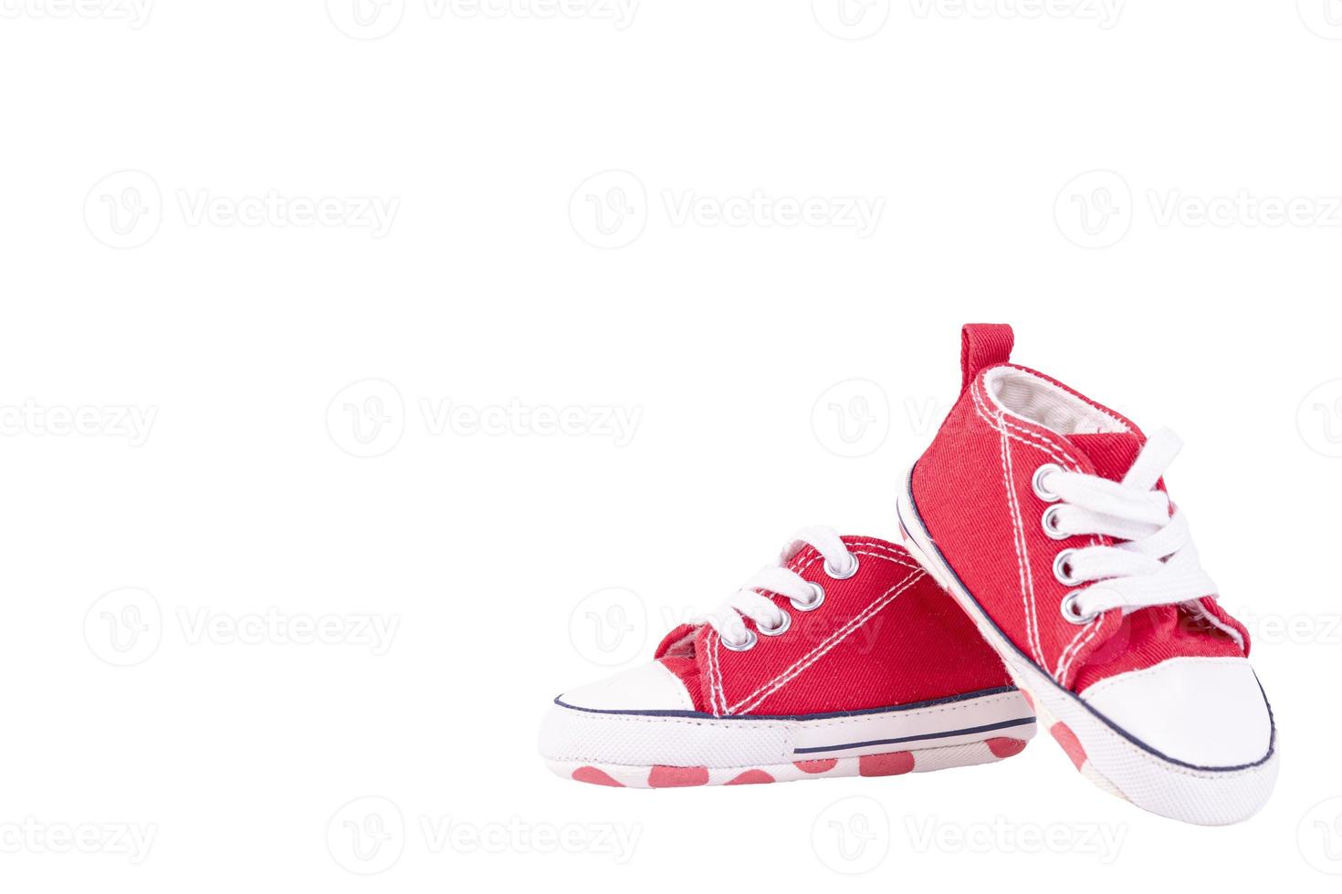 A pair of children's red sneakers on a white isolated background. photo