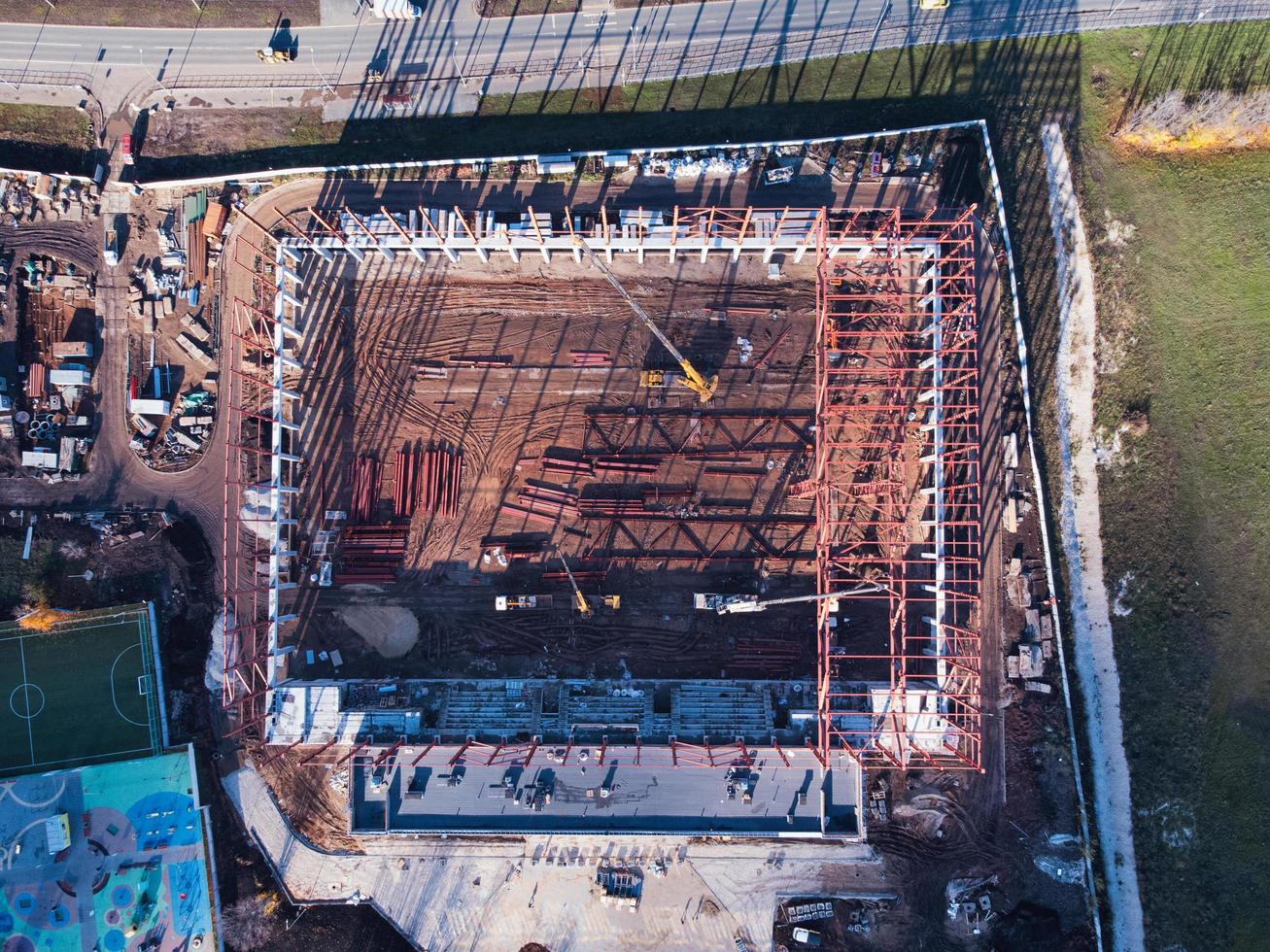 Aerial top down view of construction site with truck cranes and elements of the metal frame. photo
