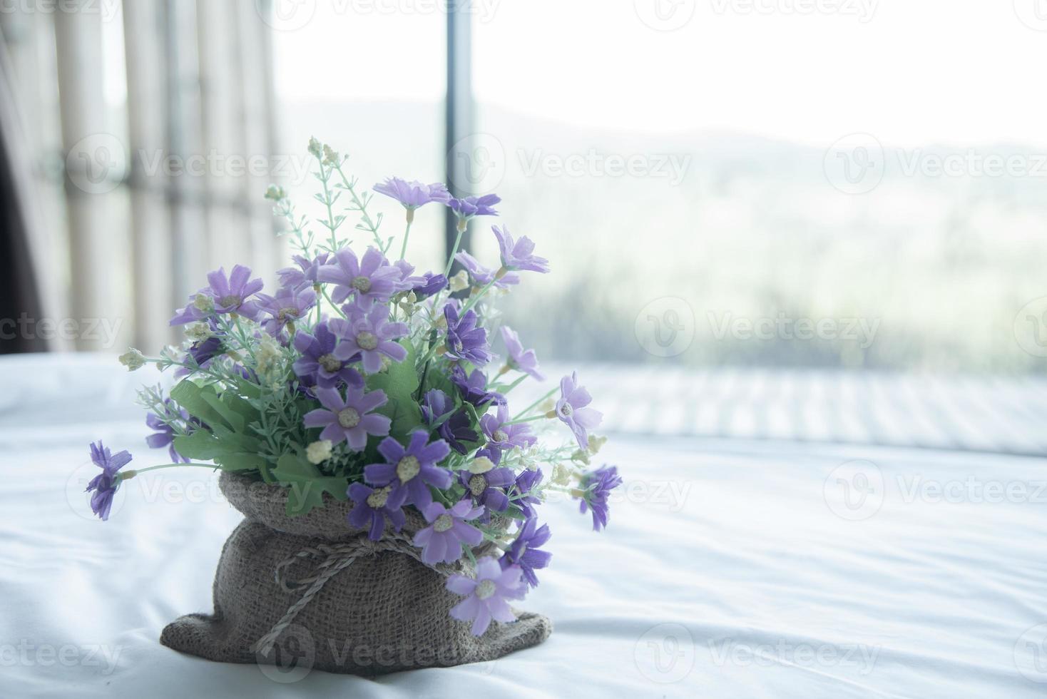 Artificial flower on the white bed, freshy and warm morning photo