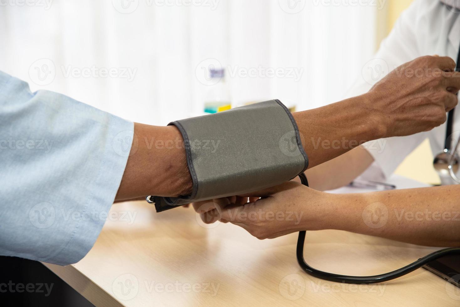 The doctor diagnos the patient' health in the hospital photo