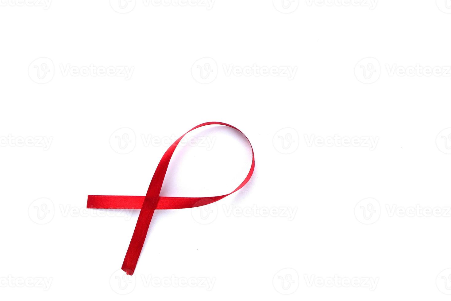 Red Support Ribbon isolated on white background. World aids day and national HIV AIDS and aging awareness month with red ribbon. copyspace area photo