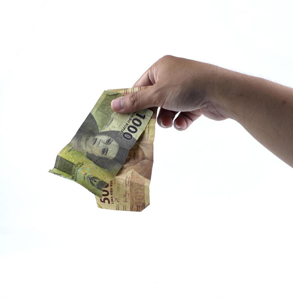 Gorontalo-Indonesia, November 2022 - hand holding Indonesian money isolated on white background photo