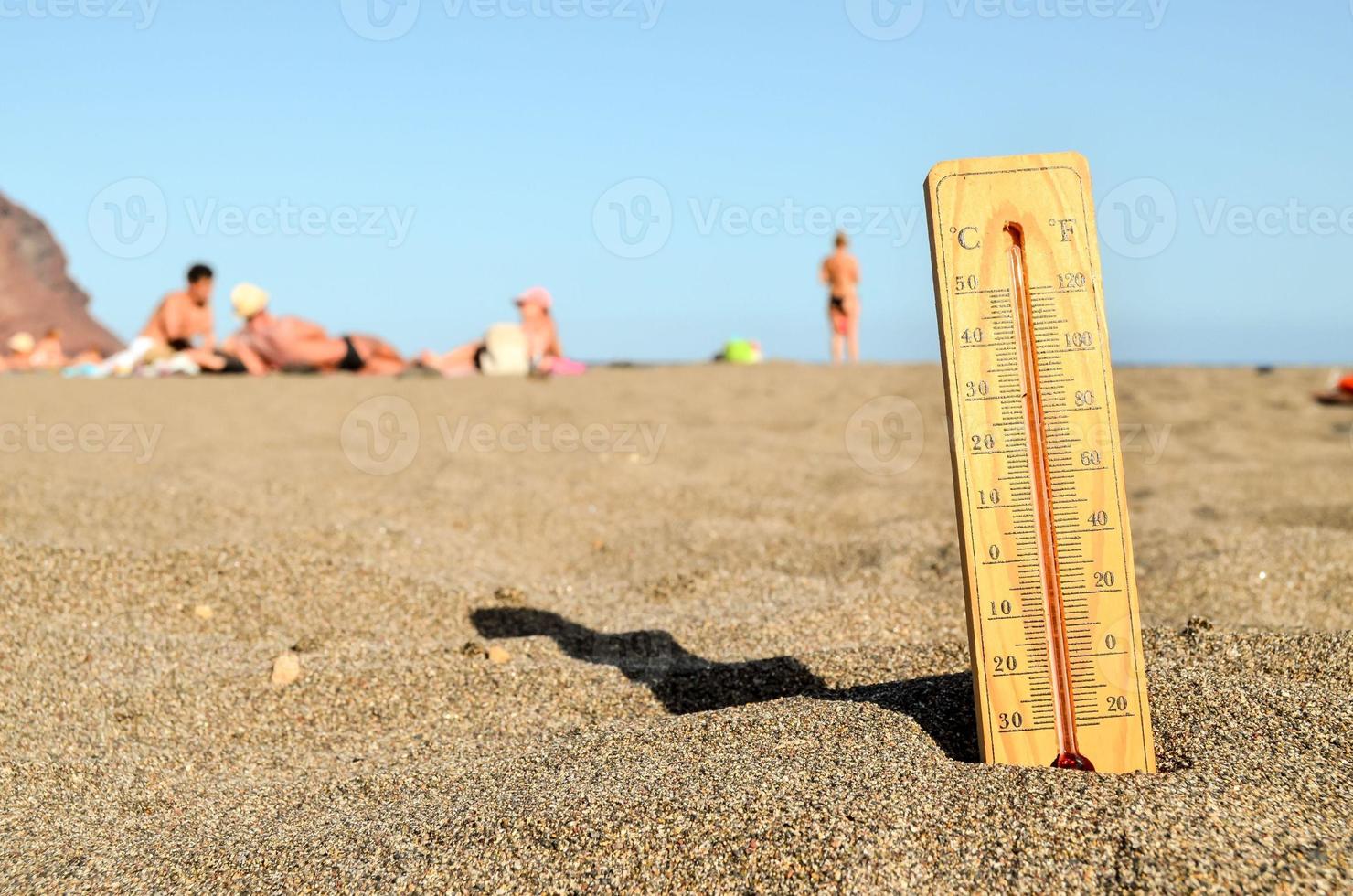 Thermometer on the sand beach photo