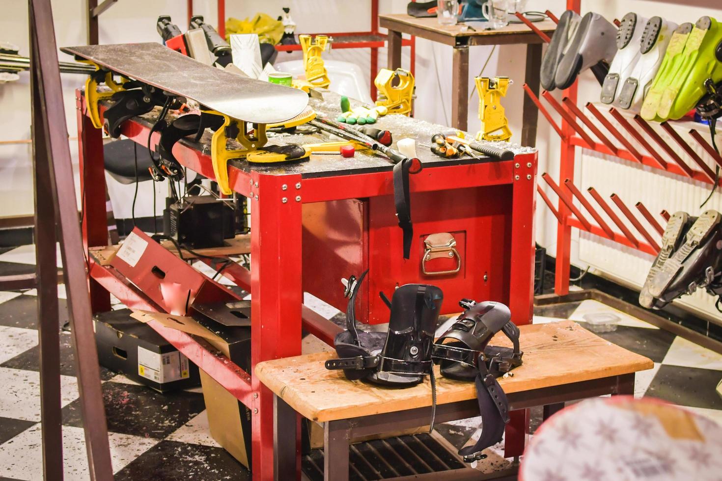 Set for the preparation of skis and snowboards, iron, brushes, scraper, ski lubricant - paraffin, skis on a black and red background. an empty space for the inscription. photo