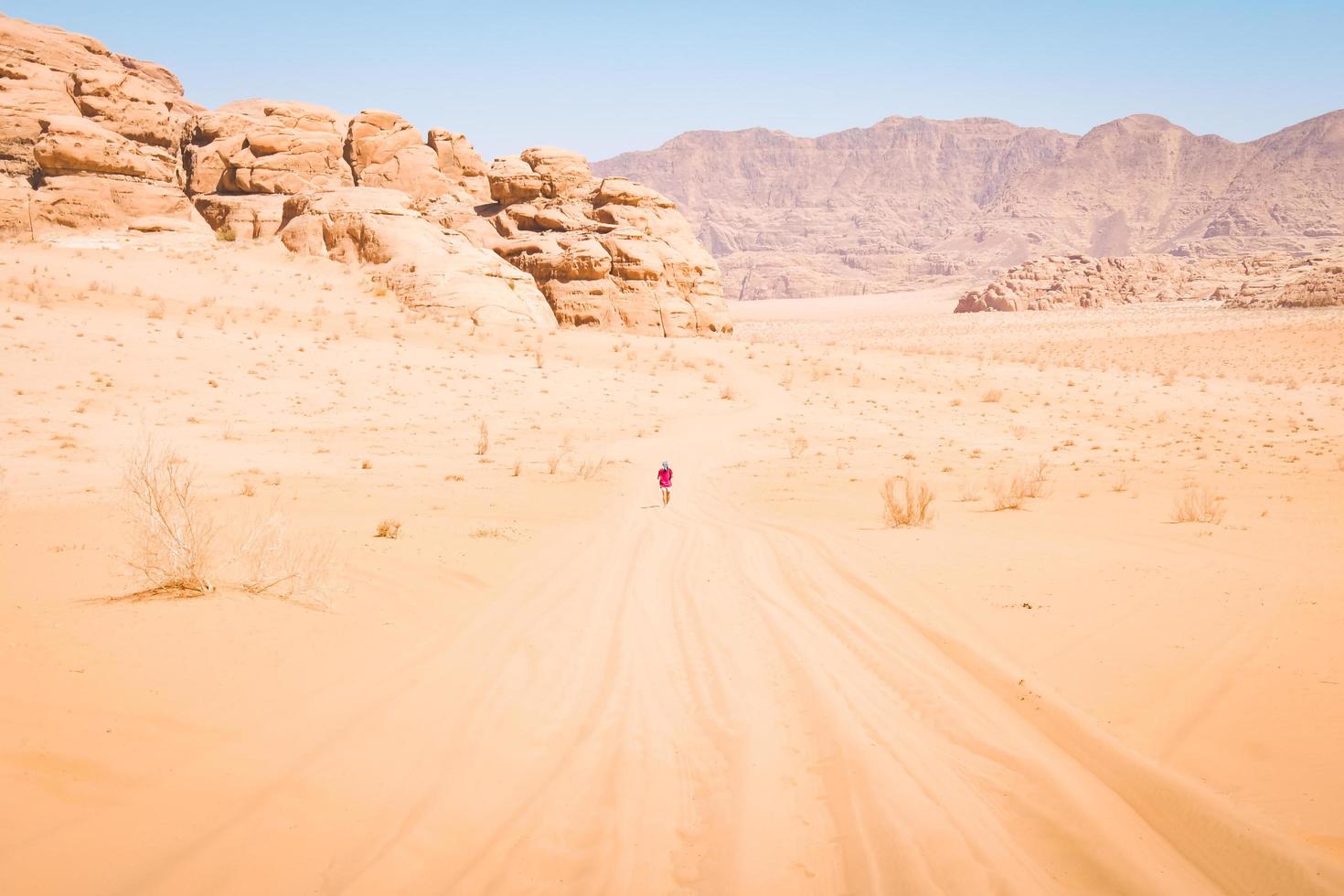 Happy joyful woman tourist stand with hands up on wadi rum desert on hike on holiday vacation in Wadi rum. Popular Wadi Rum desert in Jordan photo