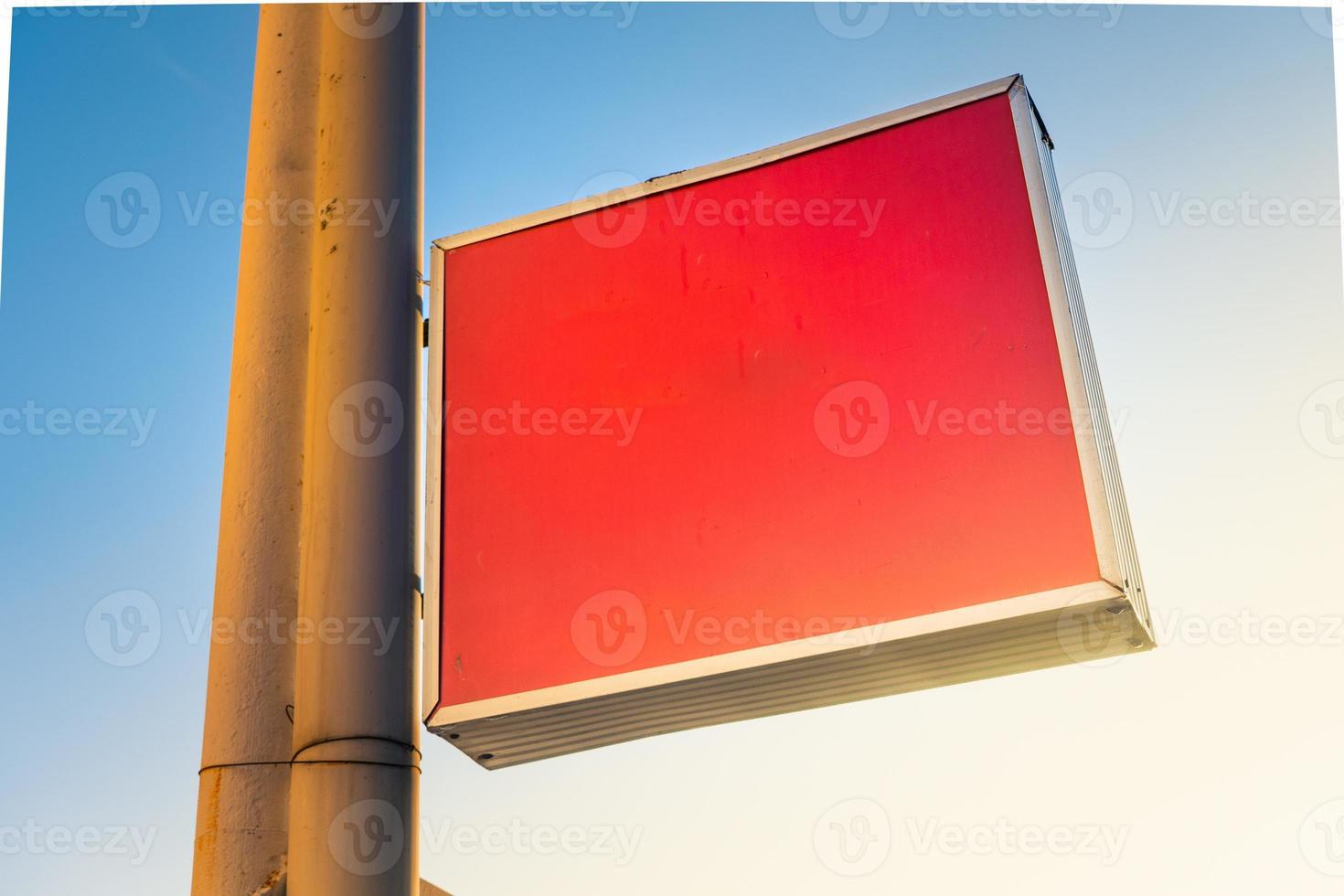Blank red plastic signboard on post. Empty mounted sign plate mock up. Clear outdoor plexiglass signage for hotel or store info mockup template. photo