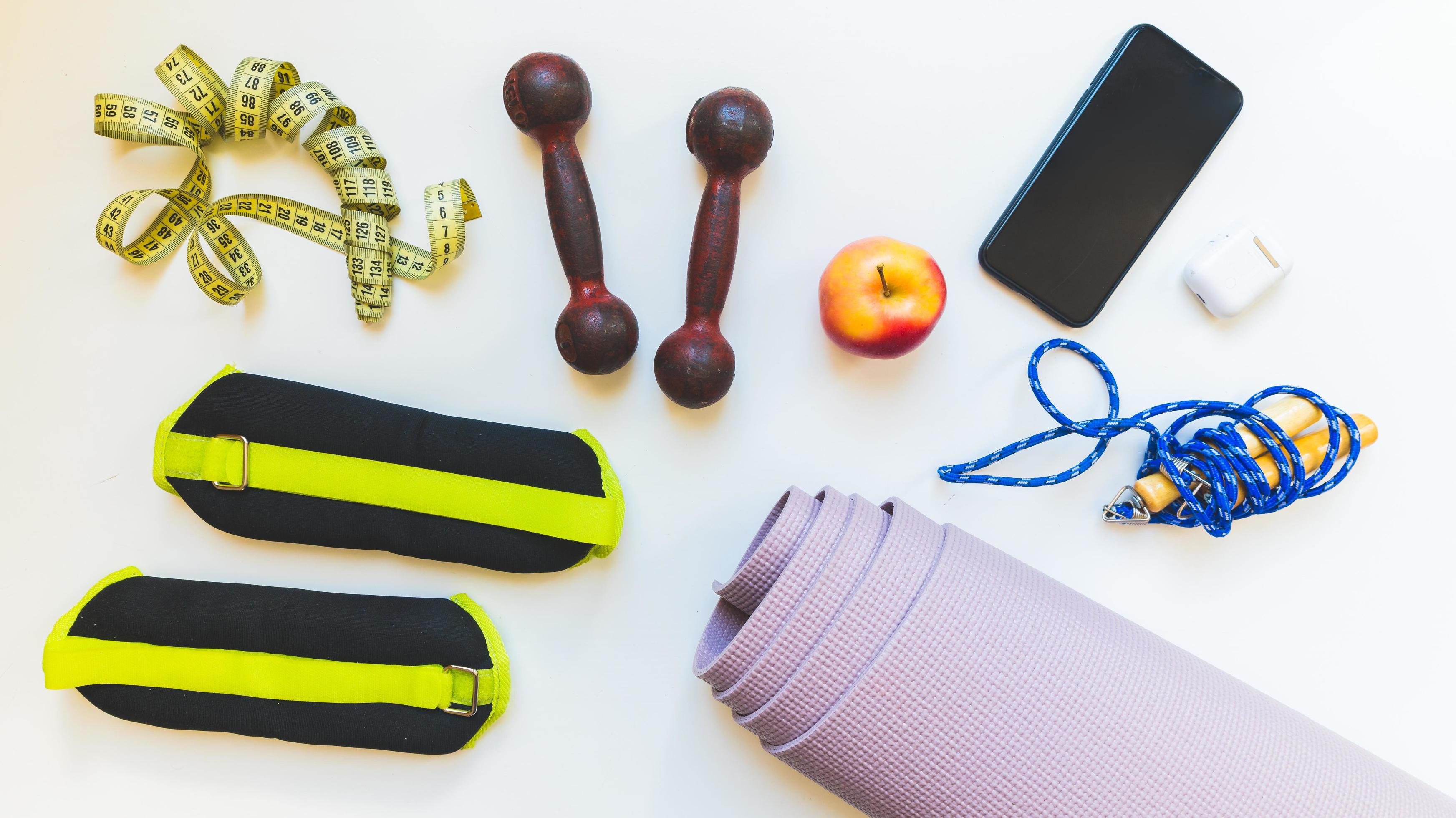 Top view Healthy female flat lay runners sports set up and fitness  equipments with yoga mat isolated on white background. Gym accessories,  loose weight, gym at home banner concept 14790067 Stock Photo