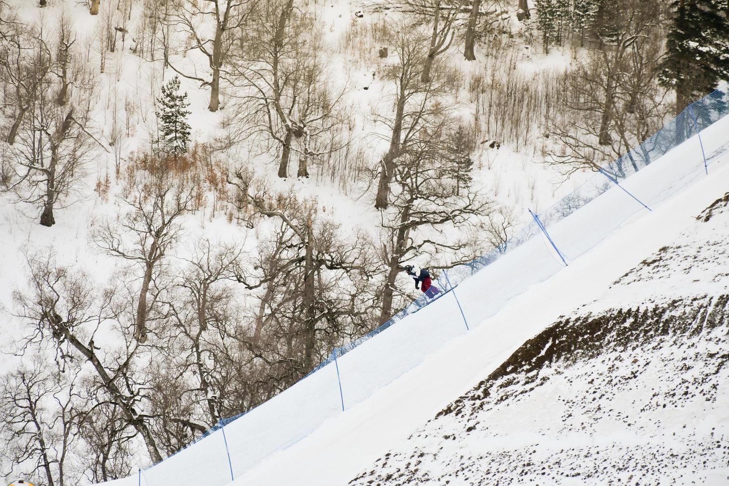 Bakuriani, Georgia - 5th March -Fis Freestyle skiing world competition . Skier go down slope in ski competition photo