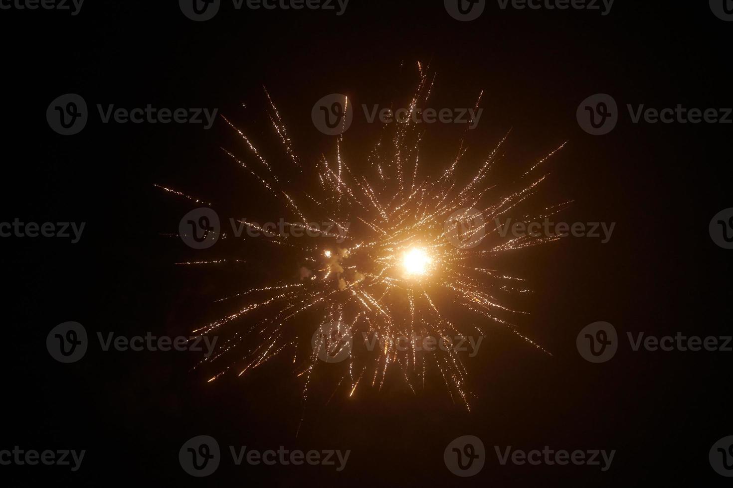 Yellow gold night fireworks bright sparkles and shiny festival explosion, glittering of sky fire photo